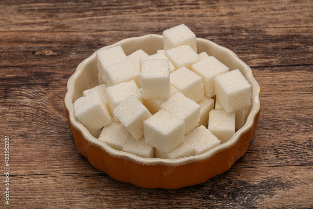 Refined white sugar cubs in the bowl Refined white sugar cubs in the bowl