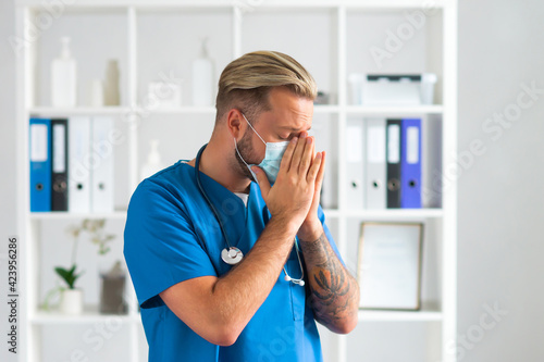 Professional medical doctor in hospital office, Portrait of young and confident physician in protective mask.