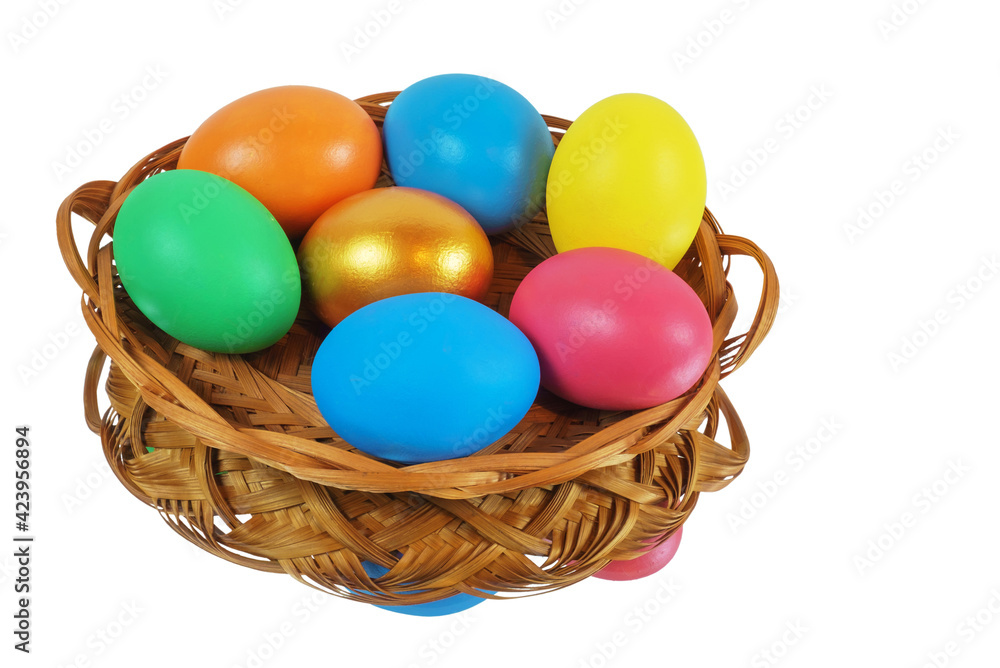Colorful Easter eggs in the basket reflecting on the white surface, isolated