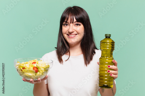 young pretty curvy woman happy expression and holding a salad photo