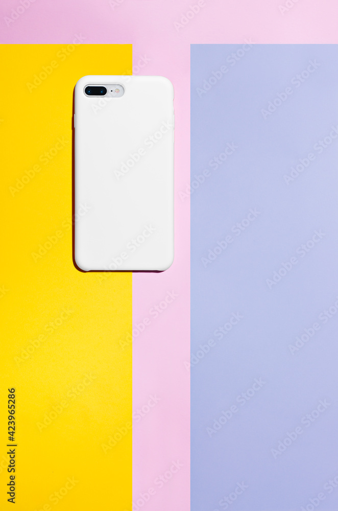White phone case mockup, smartphone back view isolated on colorful paper background White phone case mockup, smartphone back view isolated on colorful paper background