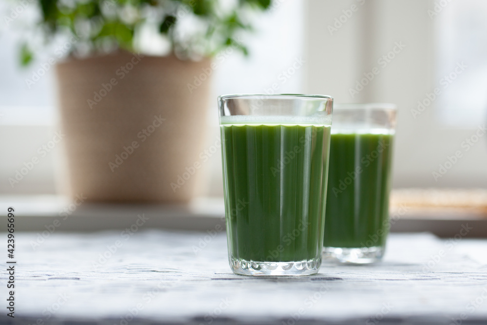 Pineapple, kiwi amd mint green smoothie on table. Pineapple, kiwi amd mint green smoothie on table.
