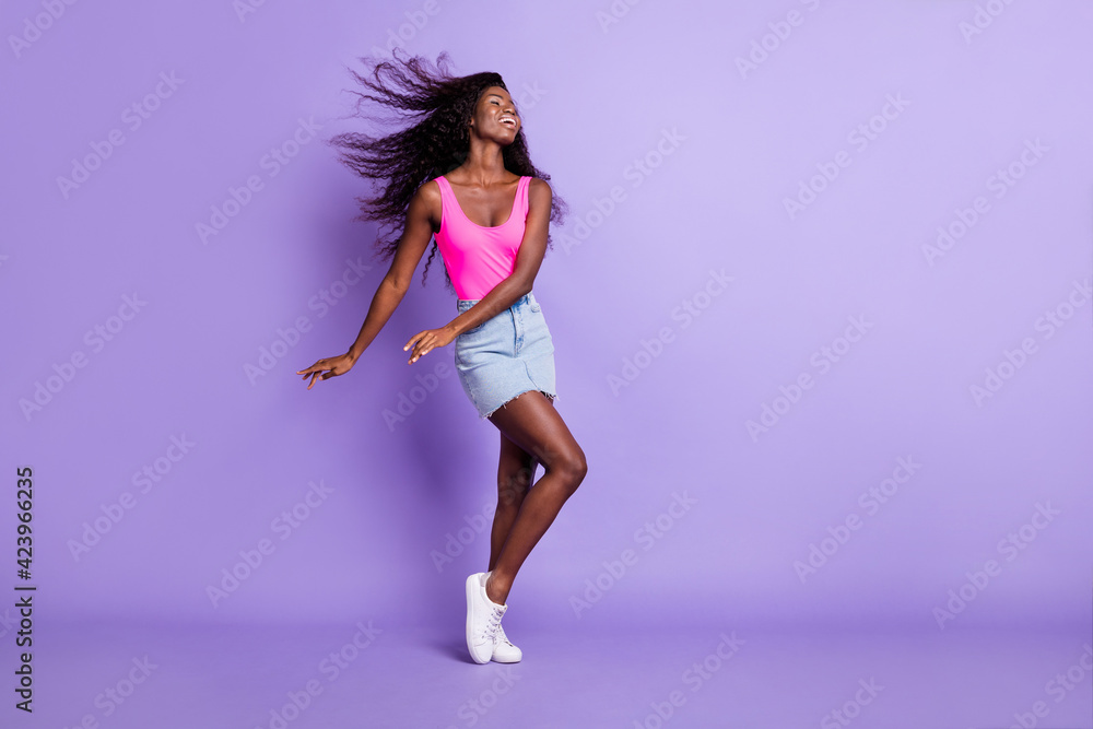 Photo of adorable pretty dark skin lady wear pink singlet dancing empty space copyspace isolated purple color background Photo of adorable pretty dark skin lady wear pink singlet dancing empty space copyspace isolated purple color background