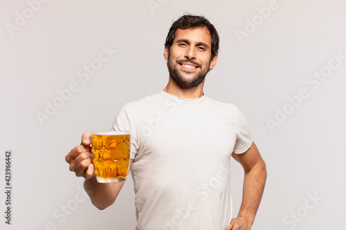 Bild auf Leinwand young handsome indian man happy expression and holding a beer