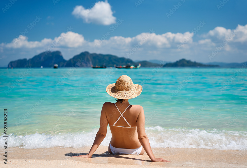 Portrait of a sensual young female in white bikini enjoying warm tropical ocean water. Portrait of a sensual young female in white bikini enjoying warm tropical ocean water.