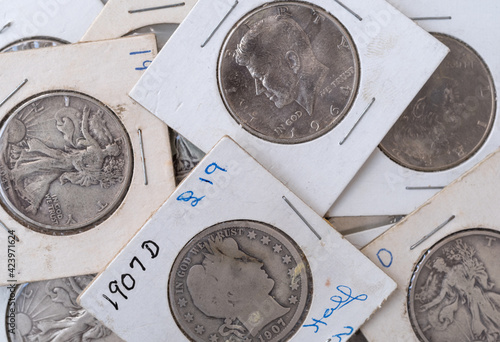 Fotografía Old coin collection in protective wrappers of half dollars close view