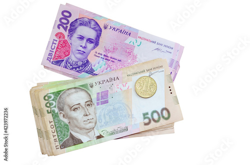 Modern ukrainian money - hryvnia. Stack of 500, 200 banknotes and one coint (kopijka) Flat lay, top view. Isolated on white background with free space for your text. Money and financial concept