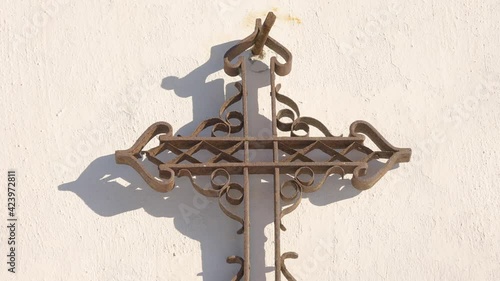 The shadow of the cross sign on the wall of the church photo