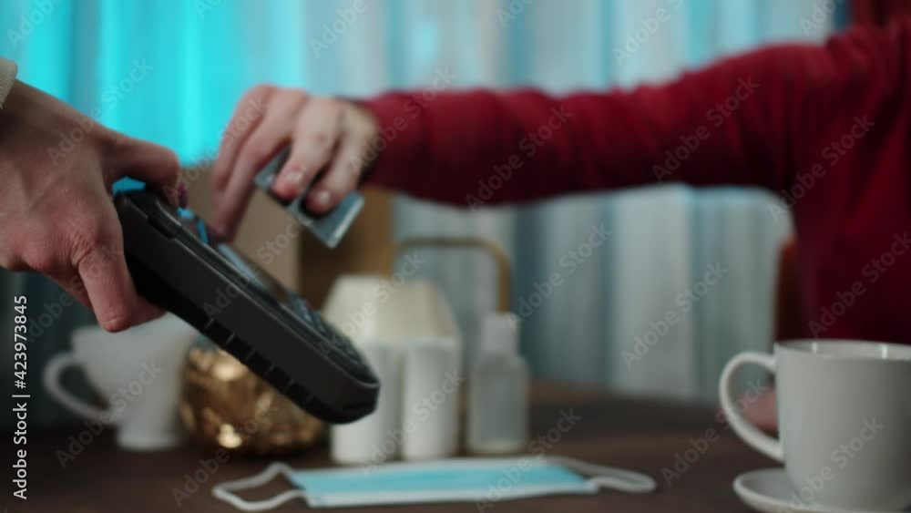Man is using contactless payment to observe safety protection. Payment by credit card at the cafe. Paying the bill and entering the PIN code. Man is using contactless payment to observe safety protection. Payment by credit card at the cafe. Paying the bill and entering the PIN code.