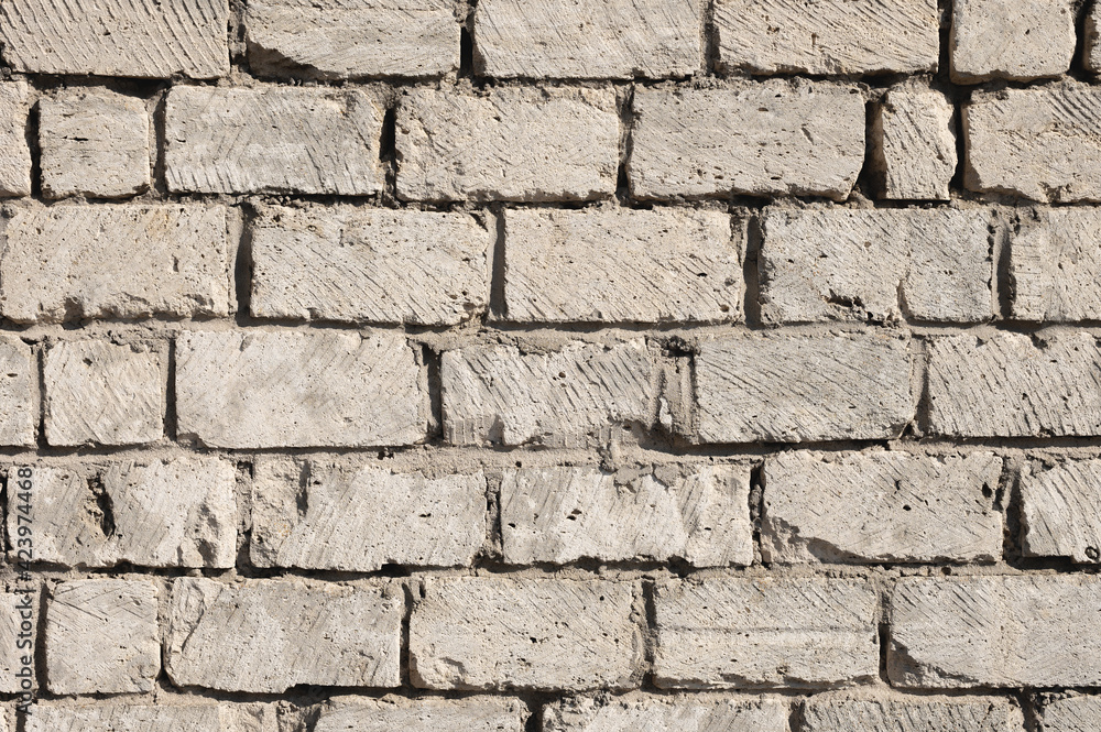 Obraz premium Wall pattern dirty cement assorted bricks. Cement-stained wall from broken bricks