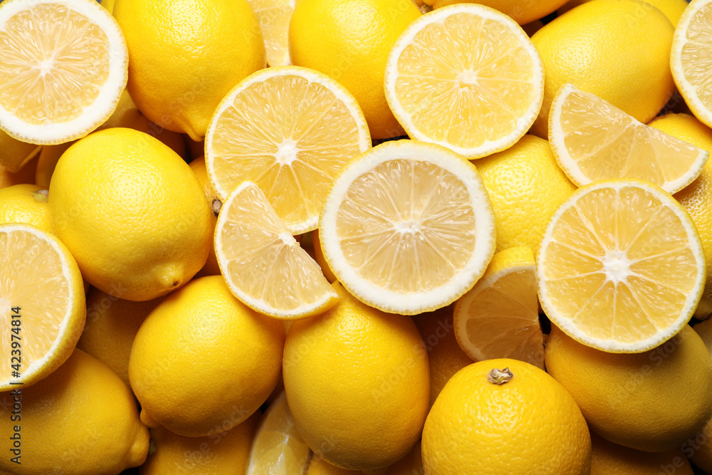 Many fresh ripe lemons as background, closeup