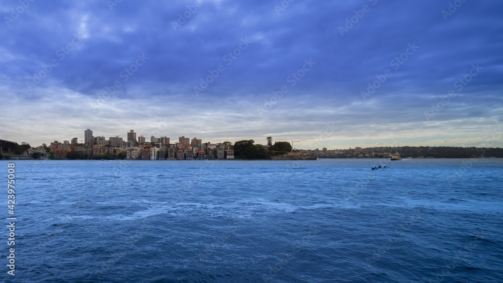 Sydney Harbour forshore viewed from the Gardens in NSW Australia on a nice sunny and partly cloudy Morning blue skies