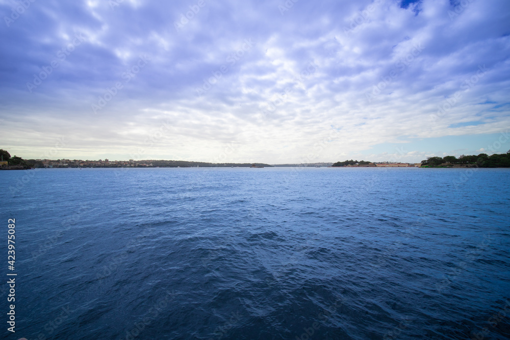 Sydney Harbour forshore viewed from the Gardens in NSW Australia on a nice sunny and partly cloudy Morning blue skies