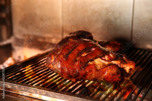 Grilling grate with pork foreshanks in oven photo