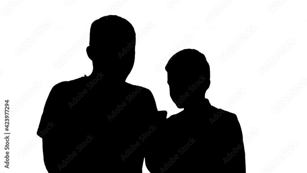 Silhouette Happy father and son watching something on the phone and smiling. Silhouette Happy father and son watching something on the phone and smiling.