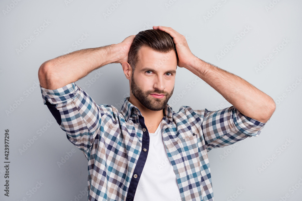 Portrait of attractive content guy wear checked shirt caressing new hairdress isolated over gray pastel color background Portrait of attractive content guy wear checked shirt caressing new hairdress isolated over gray pastel color background