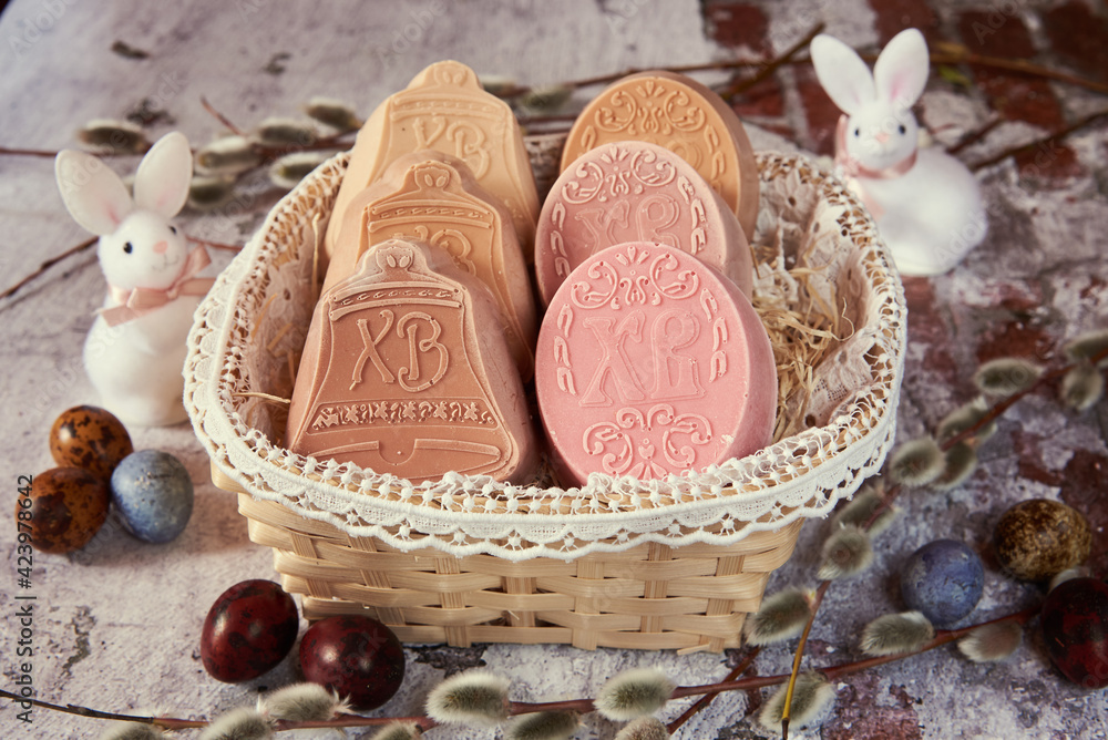 Delicate handmade Easter soap in a wicker basket and a variety of Easter decor.