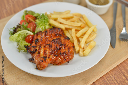 delicious plate of western food chicken chop with fries and salad