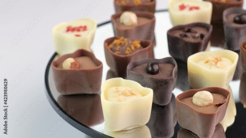 delicious chocolate candies or pralines, mixed assortment with nuts, dry berries, dark and milk chocolate, confectionery facrory, 4K delicious chocolate candies or pralines, mixed assortment with nuts, dry berries, dark and milk chocolate, confectionery facrory, 4K