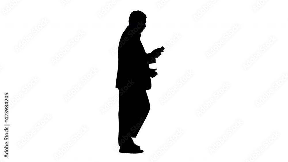 Silhouette Senior businessman walking and making a call. Silhouette Senior businessman walking and making a call.