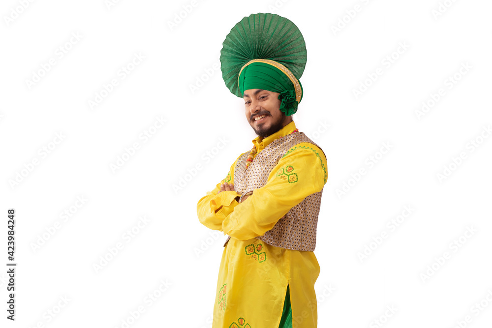A Bhangra Dancer Standing with his hands folded.	
