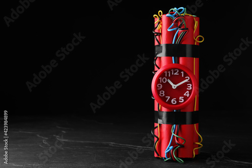 Naklejka Explosive dynamite time bomb on black background. Space for text