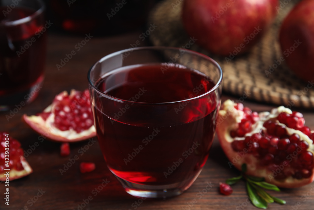 Pomegranate juice and fresh fruits on wooden table Pomegranate juice and fresh fruits on wooden table