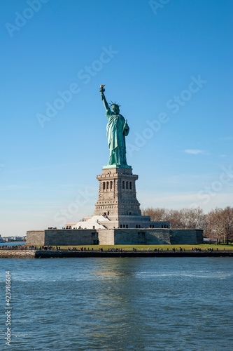 Statue of Liberty, an iconic neoclassical copper sculpture representing Libertas, the Roman goddess of liberty, holding up a torch and occupying a large pedestal on Liberty island, New York City, USA © Ana