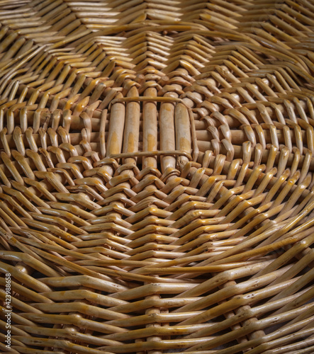 Close-up of a circular textured wicker pattern of a wooden basket.
