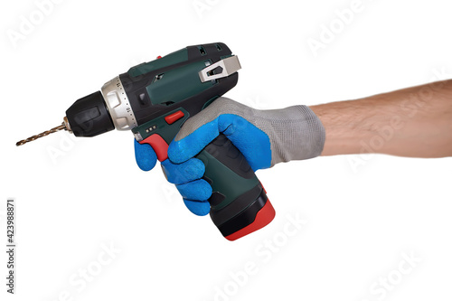 A man's gloved hand holds a drill
