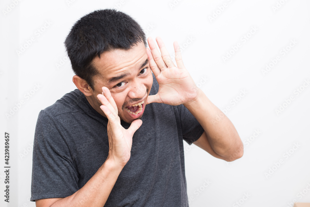 Business young asian man wear t shirt showing hand with facial face Business young asian man wear t shirt showing hand with facial face