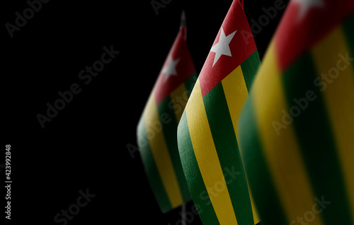 Small national flags of the Togo on a black background photo