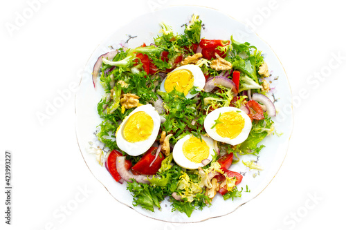 salad with lettuce, eggs,onions,nuts and tomatoes