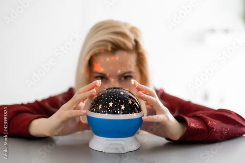 Beautiful woman holding a magical ball photo