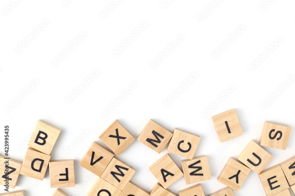 Top view the distribution of letters on wooden tiles scraped in a square shape Isolated on white background. with copy space Top view the distribution of letters on wooden tiles scraped in a square shape Isolated on white background. with copy space