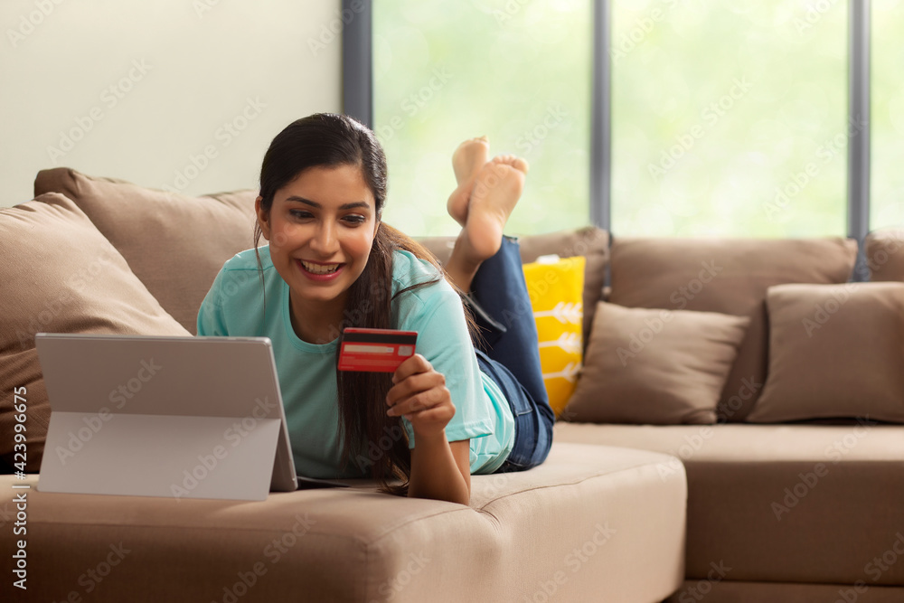 A woman with laptop and credit card shopping online. A woman with laptop and credit card shopping online.