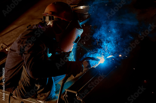 The sparks flew as the worker was welding steel © jeson