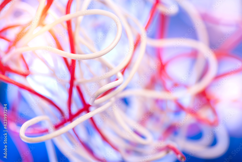 Many tangled colored electrical cables as background