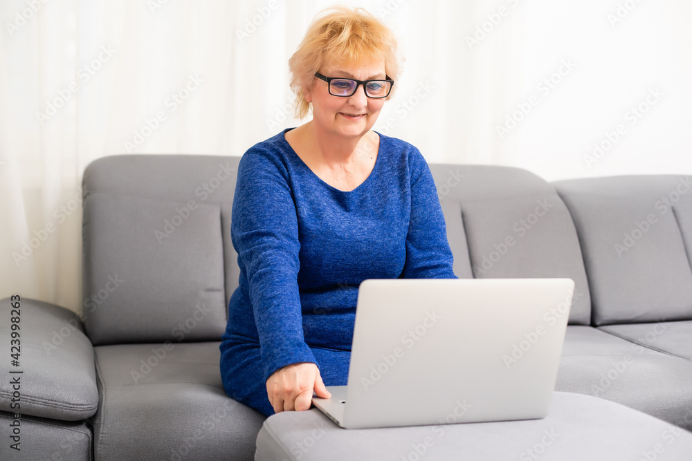 happy elderly woman using laptop computer at home happy elderly woman using laptop computer at home