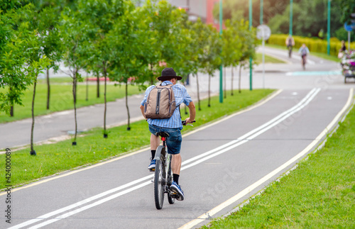 Wallpaper Mural Cyclist ride on the bike path in the city Park
 Torontodigital.ca
