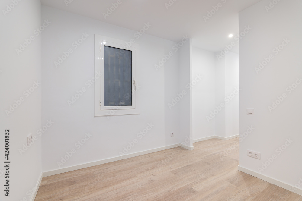 Fototapeta premium Empty white room with a window with a lattice. Modern apartment is after renovation