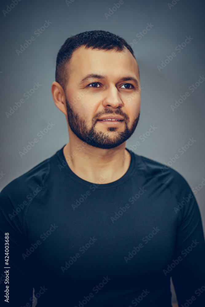 Fototapeta premium Confident bearded man with crossed hands isolated on gray background.