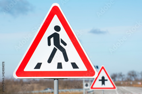 Road sign warning of a crosswalk. Regulation of traffic on a highway.