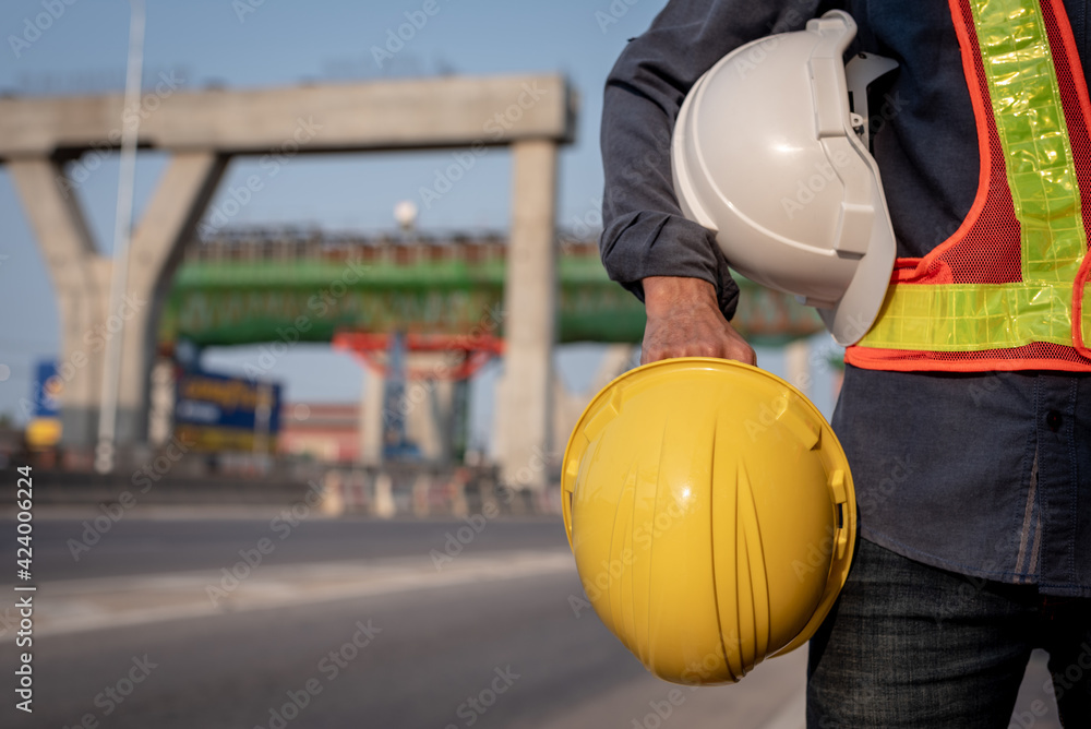 yellow and white helmet with an engineer who built an elevated road yellow and white helmet with an engineer who built an elevated road