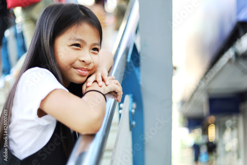 Beautiful asia child girl smile traveling on walking street.
