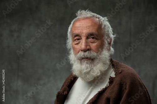 Portrait of old man wirth beard and ancient attire