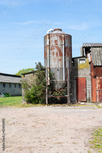 Vertical photo of an old rusty grain silo