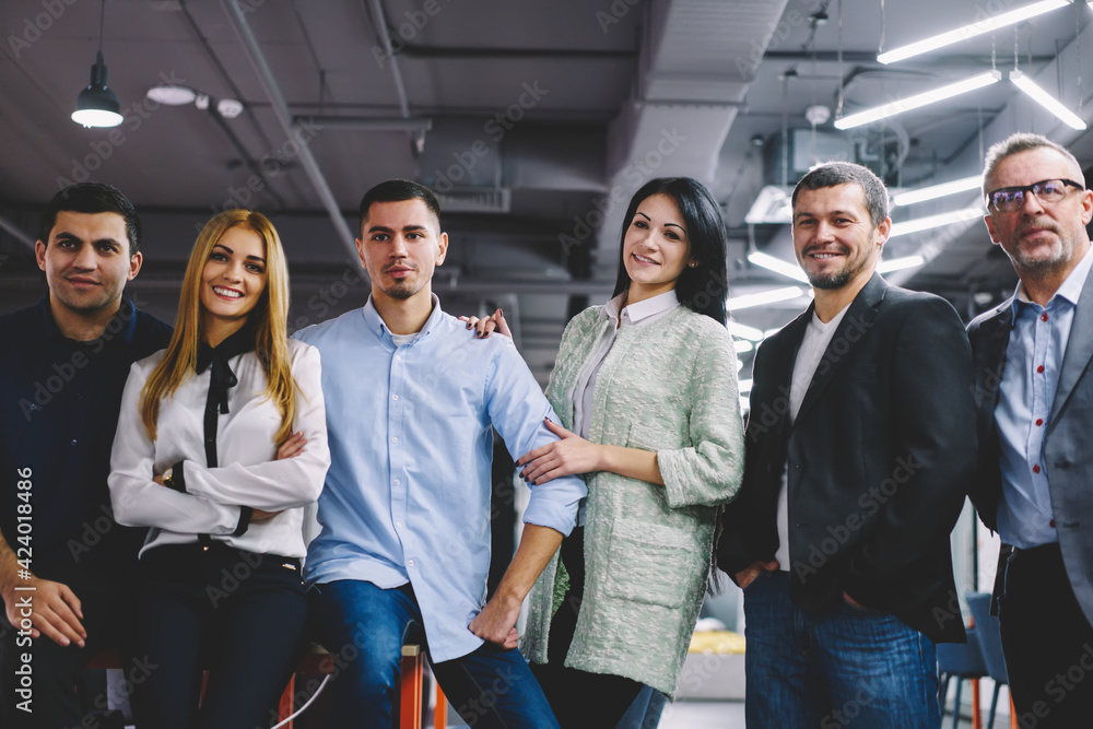 Obraz premium Half length portrait of successful male and female colleagues looking at camera during collaborative meeting for building competitive team, smart casual corporate directors posing during time on job
