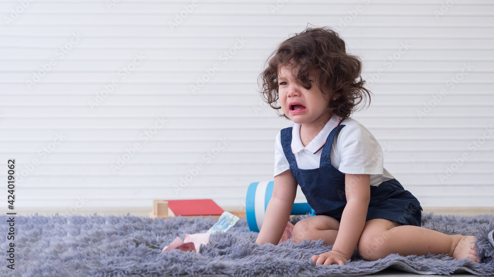 Cute little girl crying on the carpet feeling upset not getting what she wants. Cute little girl crying on the carpet feeling upset not getting what she wants.