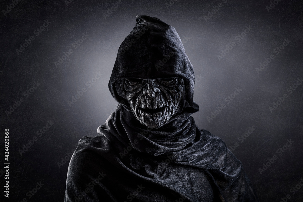 Portrait of a scary figure in hooded cloak Portrait of a scary figure in hooded cloak
